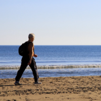 Man Walking Down Beach